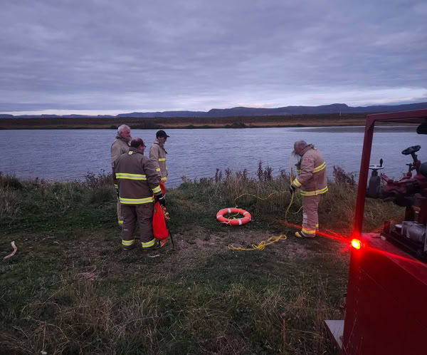 Firefighters in protective gear extinguish a fire in Chewelah, WA, showcasing teamwork and bravery.
